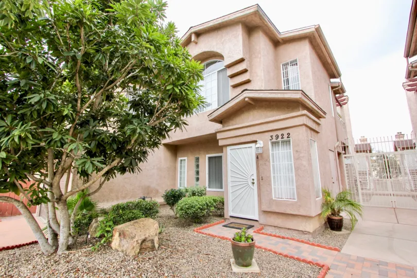 A sunny day in the area of Cameo, gates entrance, door, condos, tree