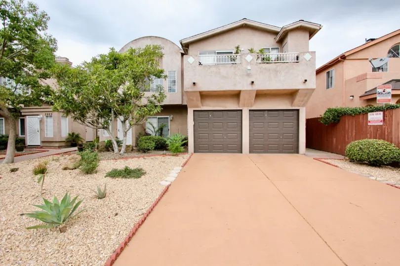 Two large brown garage doors at the end of a driveway inside Cameo in North Park CA