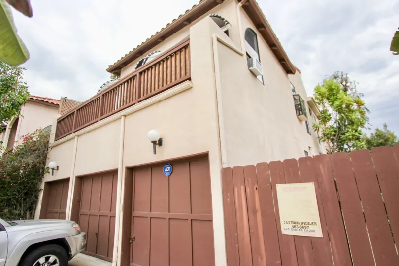 car is placed in front of the house and light fixed at the wall of the house