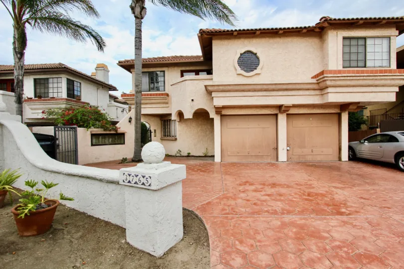 The palm trees in front of Casa Frontera 1 in North Park, California is swaying in wind.