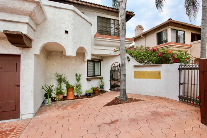 A sunny day in the area of Casa Frontera II, condo, gate, potted plants, palm tree