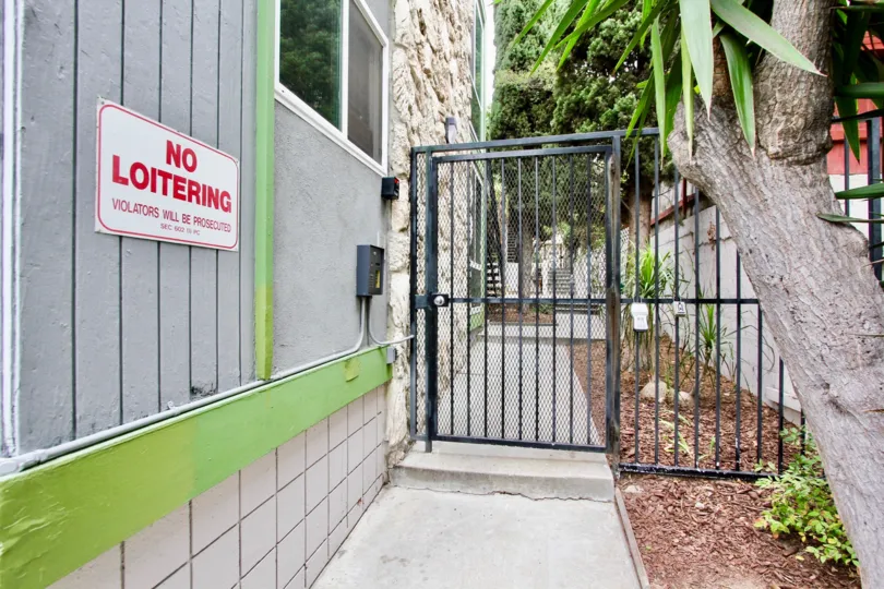 Security gate entrance next to building at Casa Riviera in North Park California