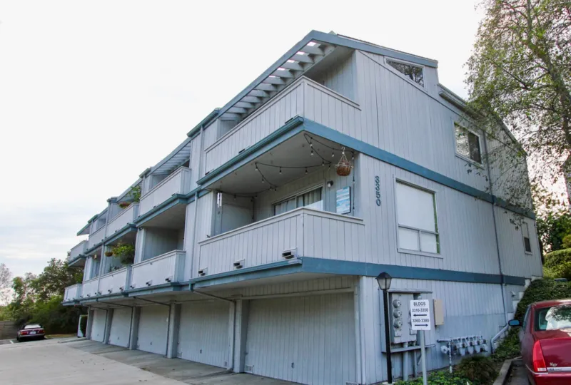Blue apartment building with parking garage in North Park California