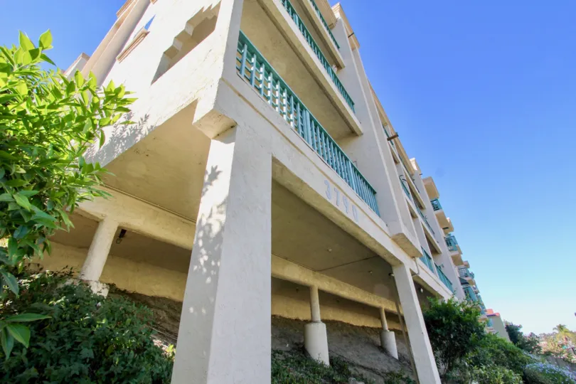 Turquoise metal railing sits on a balcony at the Coral Ridge condos
