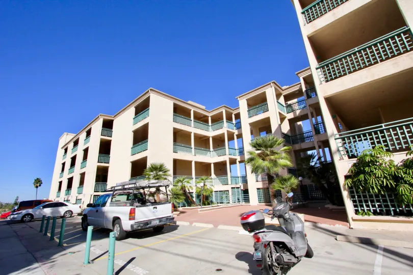 Driveway and parking area beneath four story residential buildings at Coral Ridge in North Park California