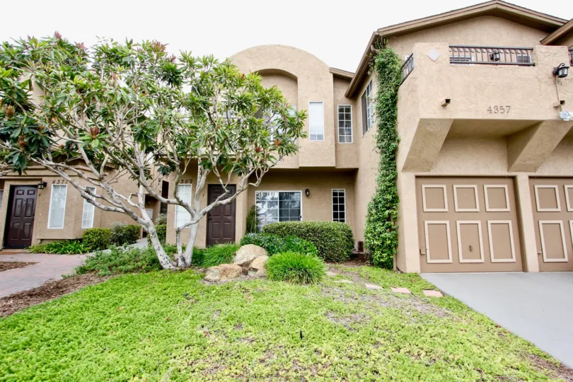 A sunny day in the area of Desert Knoll, garage, door, tree, driveway