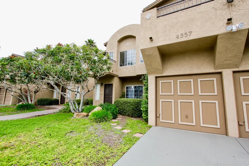 a sunny day in the area of Desert Knoll, trees, garage, entrance, parking lot