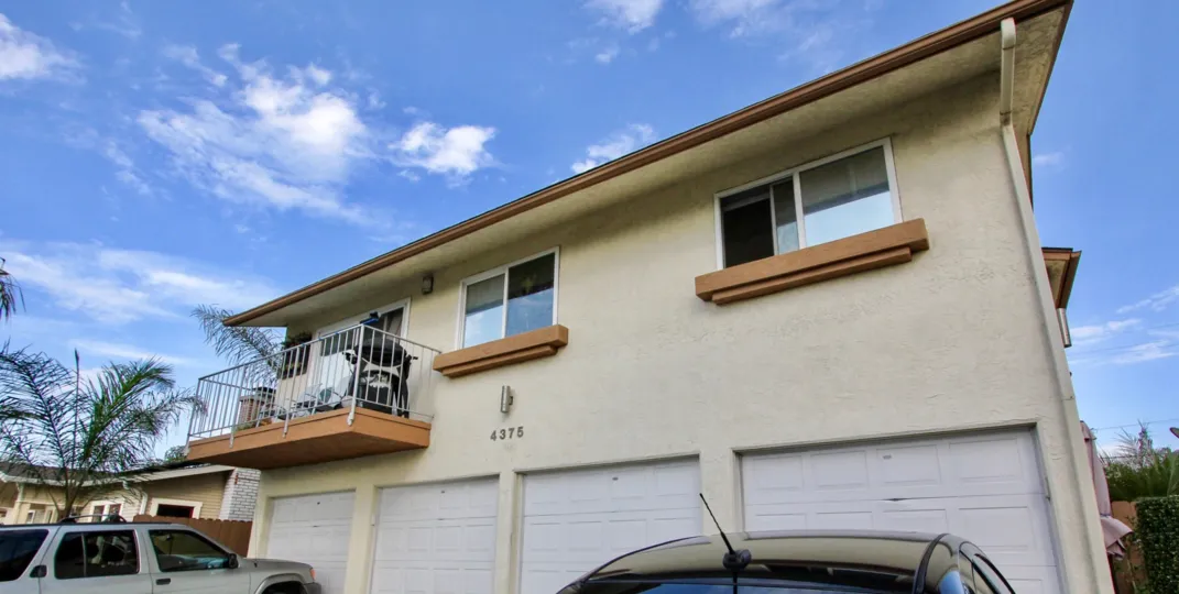 A sunny day in the area of Felton Terrace, condos. garage, cars, palm tree