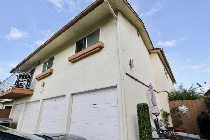 A sunny day in the area of Felton Terrace, condos. garage, cars, palm tree