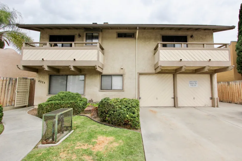 Two sand coloured homes with a balcony, a front porch and a small garden in the Florida Park community in North Park, California