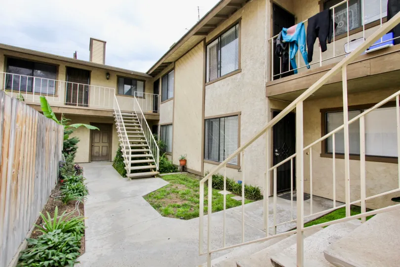 The yard of two storied houses with stairs on the exterior