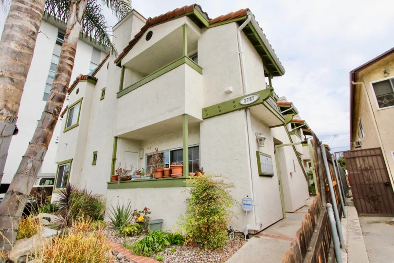 Grim Townhomes community North Park California fence balcony landscaping shrub palm trees tile roof
