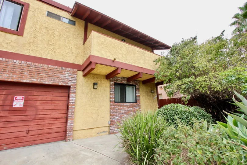 Red wood garage door with red bricks inside Hamilton Chateau in North Park CA