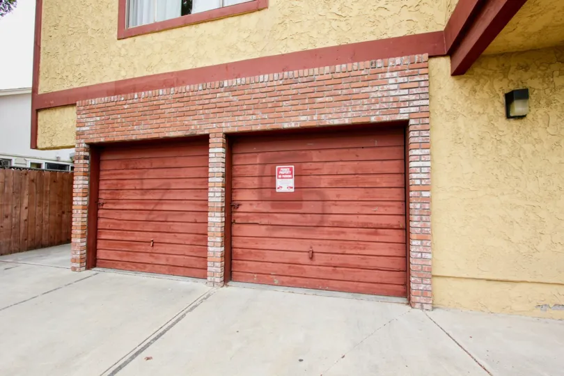 Faint graffiti is visible on two garage doors at Hamioton Chateau