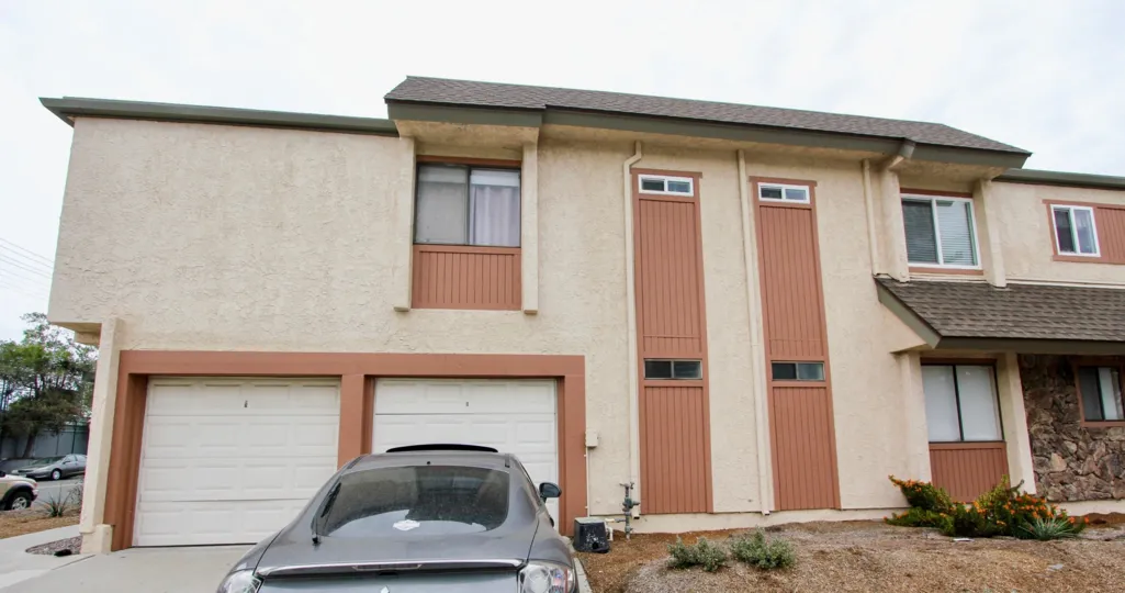 A front view of the garage and stucco sided house in Idaho Villas