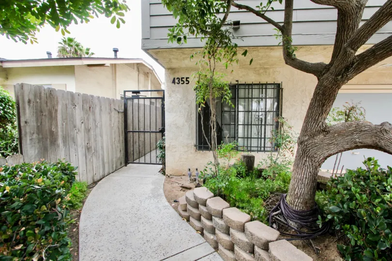 A sunny day in the area of Kentwood Condos, gate, tree, walkway, window