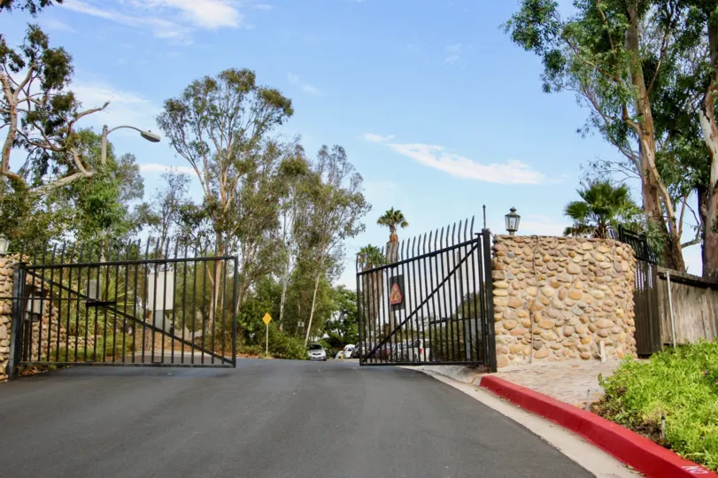 Front gate view with bright sky, La Hacienda, North Park, California