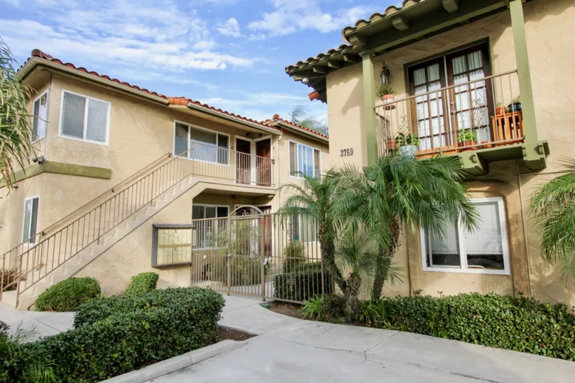 A pleasant day at La Hacienda park with secured gate and stairs to upstairs with many windows