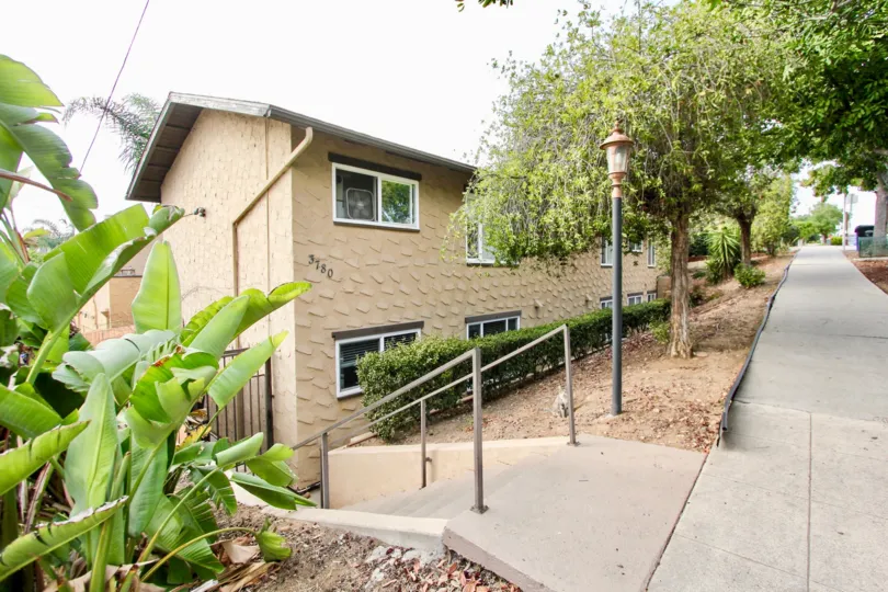 the sidewalk and entry stairway to an apartment complex in the Las Casitas neighborhood of North Park, CA