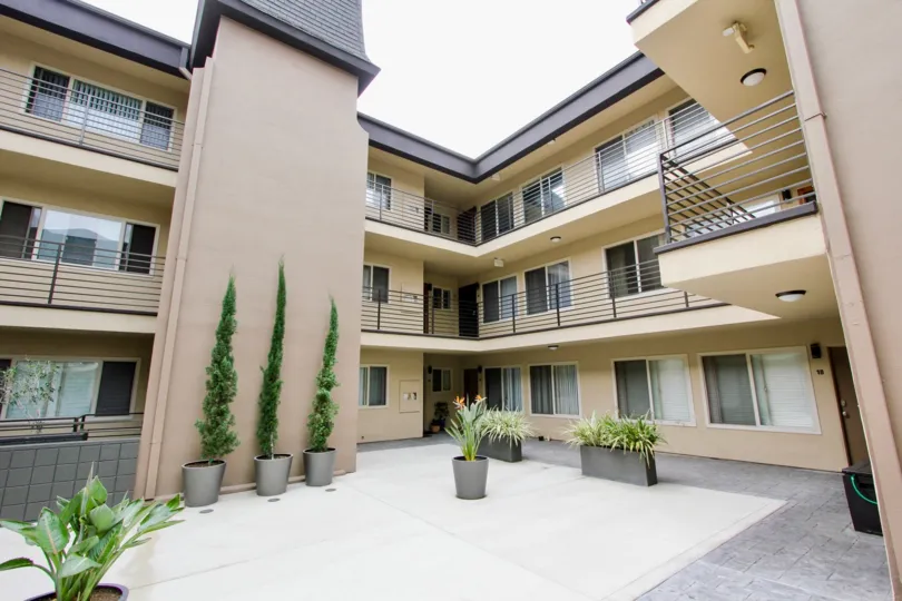 Louisiana Condominiums outdoor courtyard with various potted plants in North Park, CA