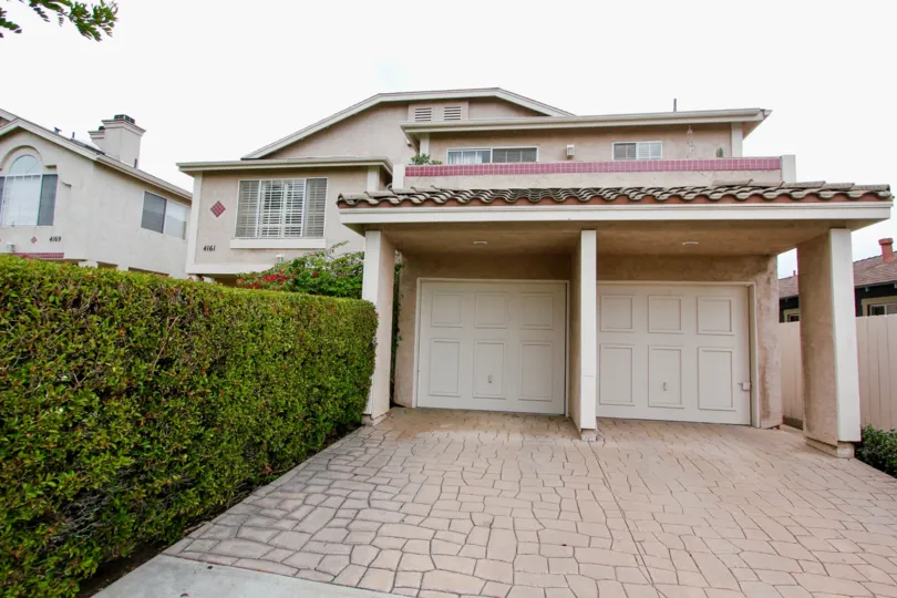 Housing with attached garages and driveway at Mardi Gras Villas in North Park California