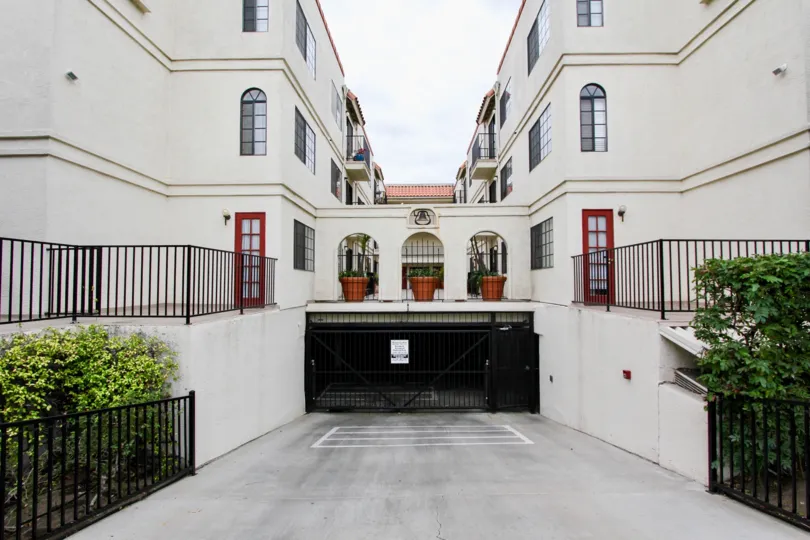 Dark black gate on underground parking entry at Mission Gardens in North Park CA
