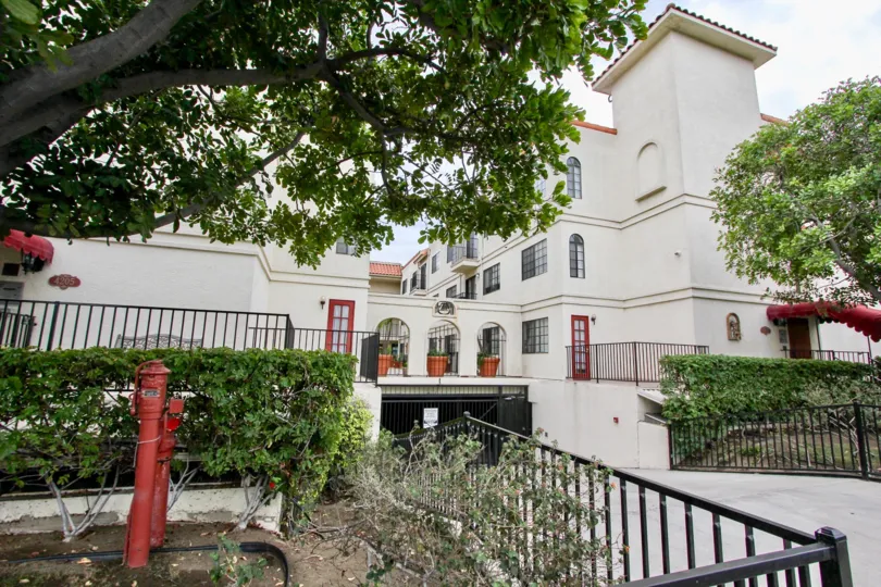 Driveway and gated parking area of multi-level Mission Gardens complex.
