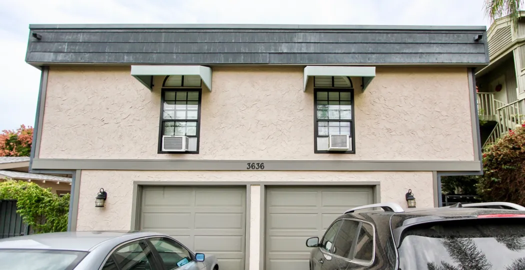 Front of house with two garage doors in bottom level in the Morley Field Townhomes