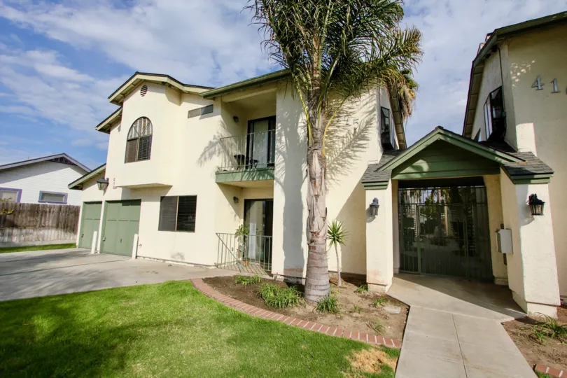 the exterior of North Park showing garage doors driveway and palm trees