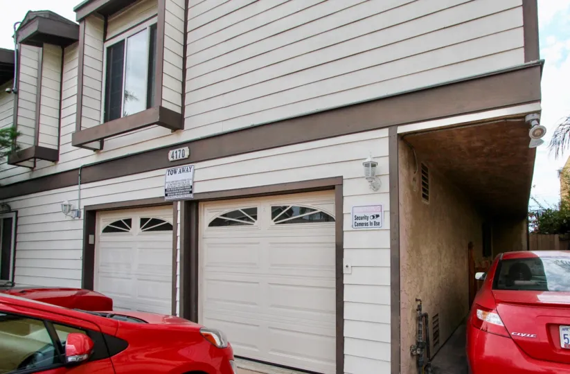 A town house in North Park View California with red cars in the driveway.