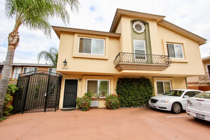 Cream house, white cars in North Park Villas in North Park California