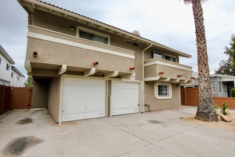 Two sand colored homes with both a balcony and a garage in the Oregon Park Community in North Park, California
