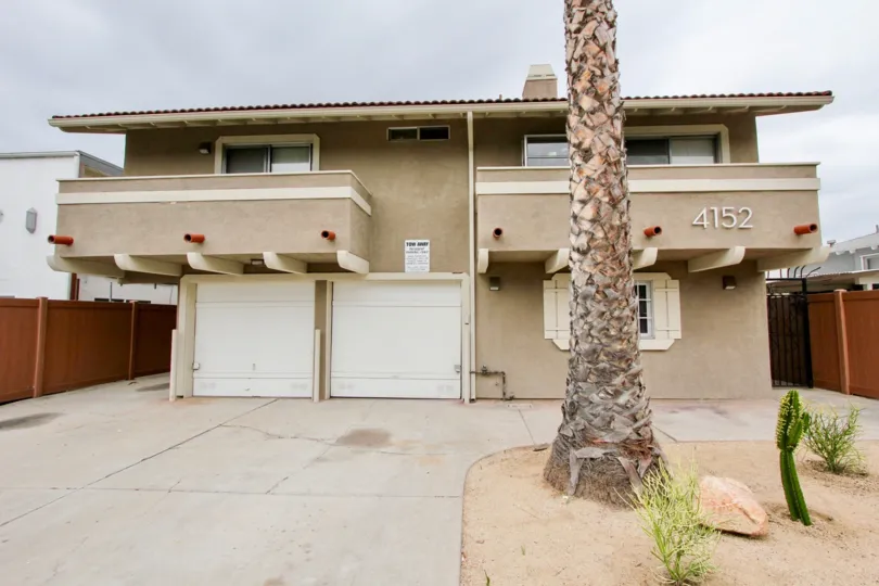 Two story brown town homes with attached white garages inside Oregon Park at North Park CA