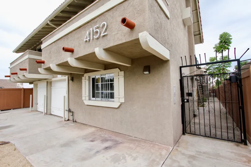 Stuco appartment building with private gated entrance in sunny North Park, California