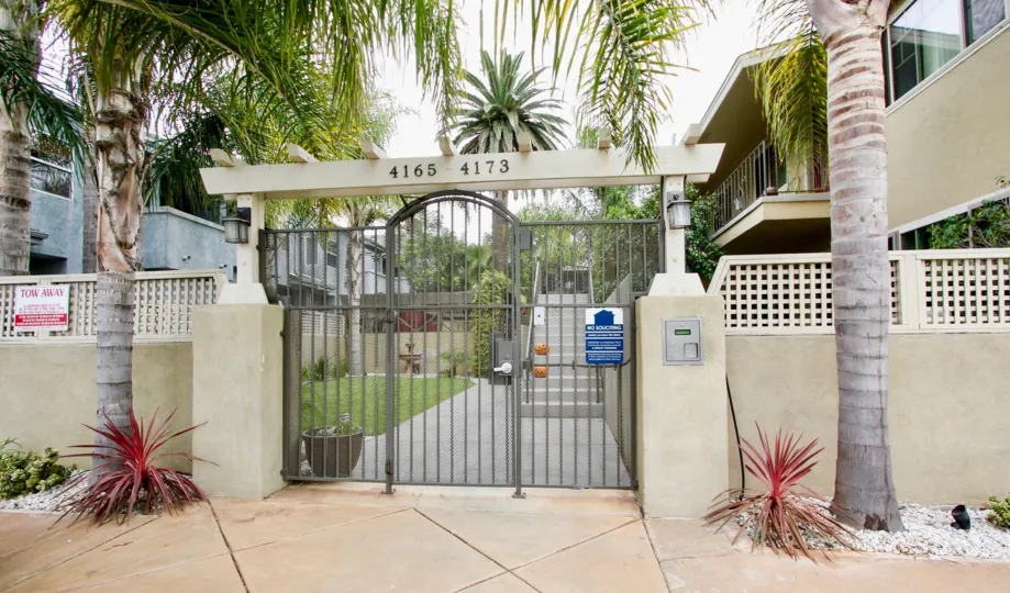 A sunny day in the area of Pacific Palms, gate, entrance, palm tree