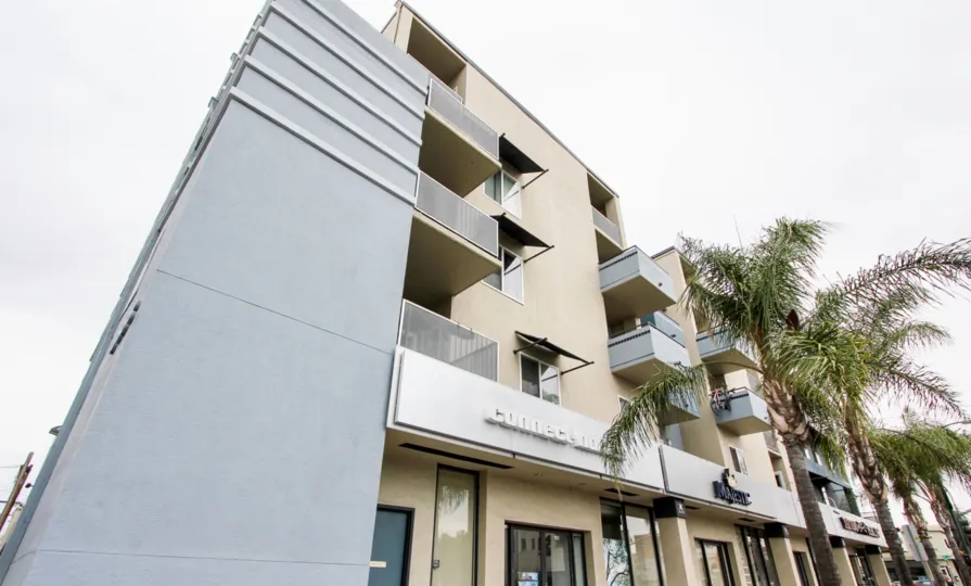 A sunny day in the area of Palisade Gardens, palm trees, high rise, condo, balcony