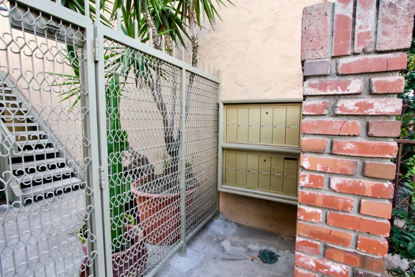 Retro brick walls against tall decorative gates at Park Balboa in North Park, CA