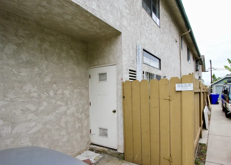The side of the apartment covered with wood walls and has one door