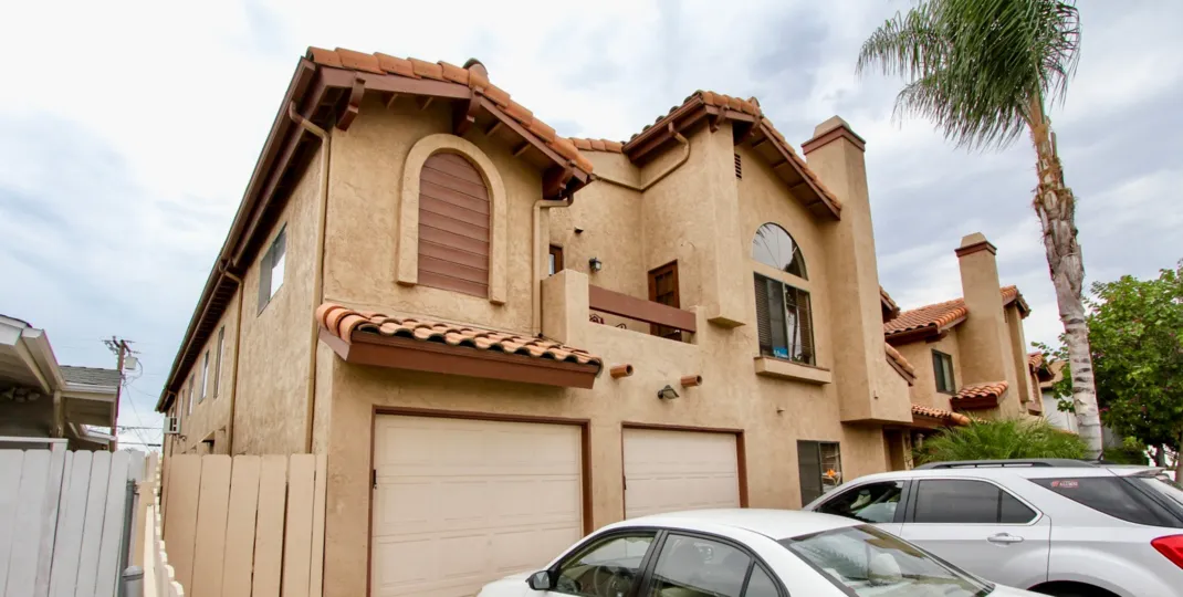 Image of the Pershing Park Villas in North Park, California. Image includes several large, two-story stucco houses.