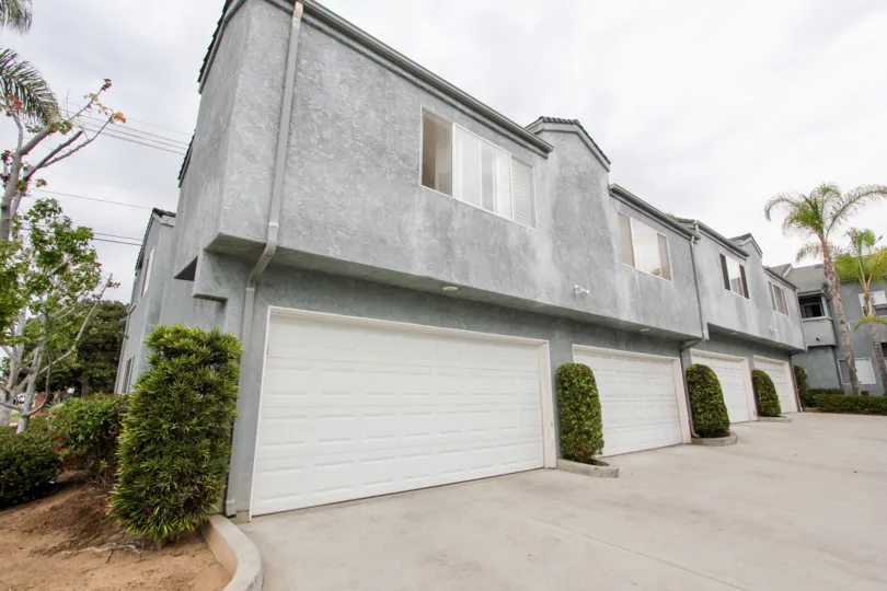 A sunny day in the area of Phoenix II, condos, garage, bushes, windows