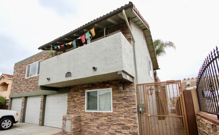 Two story residential building with security gate entrance at Rio Grande in North Park California