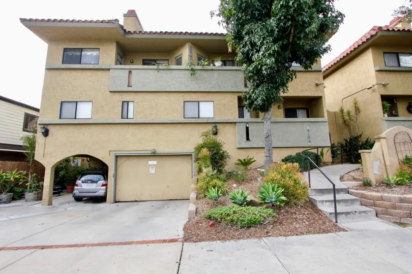 A sunny day in the area of Spanish Oaks I, condos, car, parking area, garage, stairs