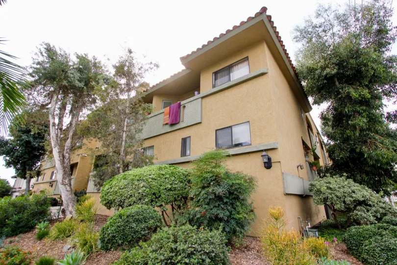 A sunny day in the area of Spanish Oaks I, condos, car, parking area, garage, stairs, towels