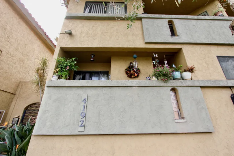 Front of a residence with balconies and little plants in the Spanish Oaks II