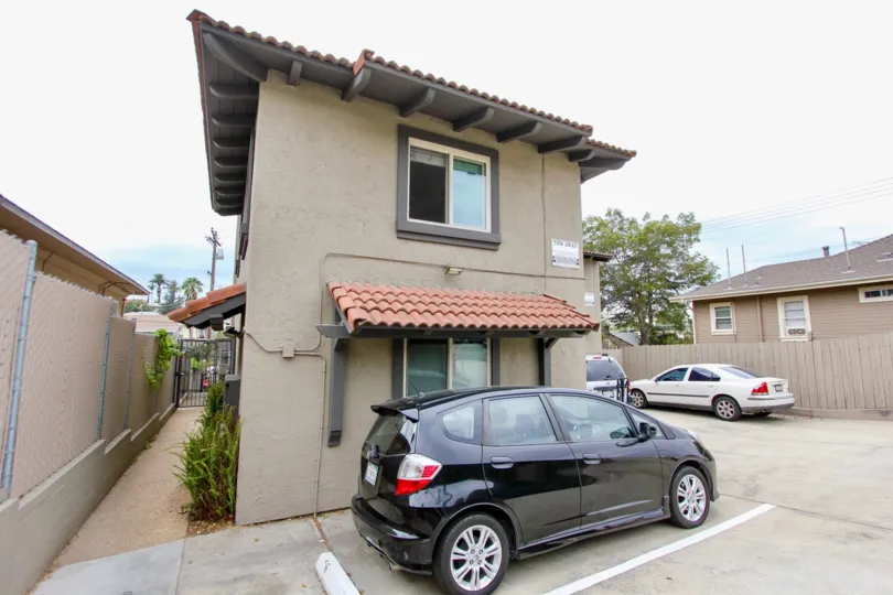 A sunny day in the area of sunburst Court, cars, driveway, condo, gate