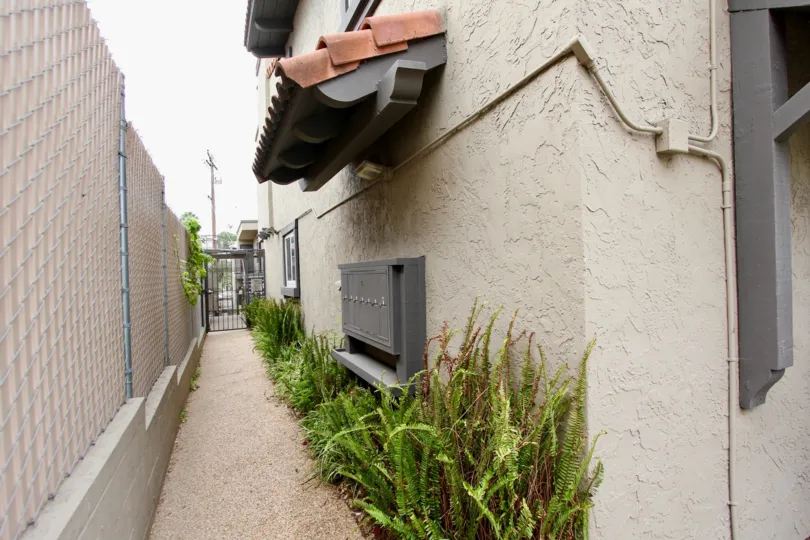 Postal box is placed upon the bushes inside the gateway of villa