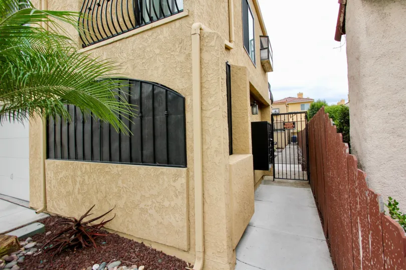 A sunny day in the area of Sunflower, condos, gated entrance, palm tree, fence