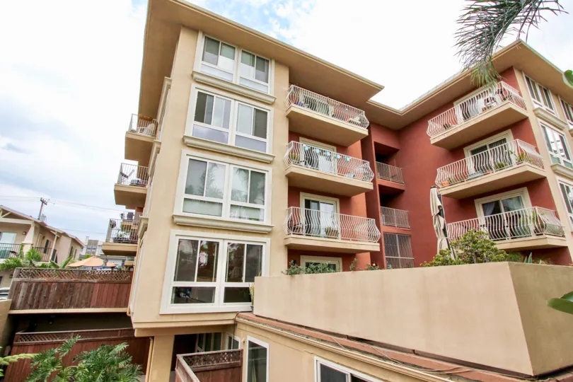 Charming Mediterranean-style apartment building with lots of windows and balconies.