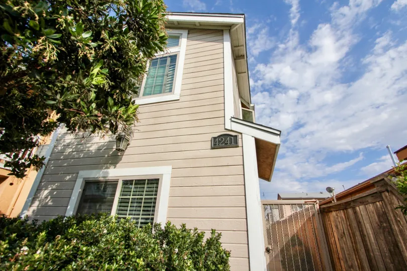 The corner view of house 4241 a two tory home with a wooden fence in the Swift Colony neighborhood of North Park, California.