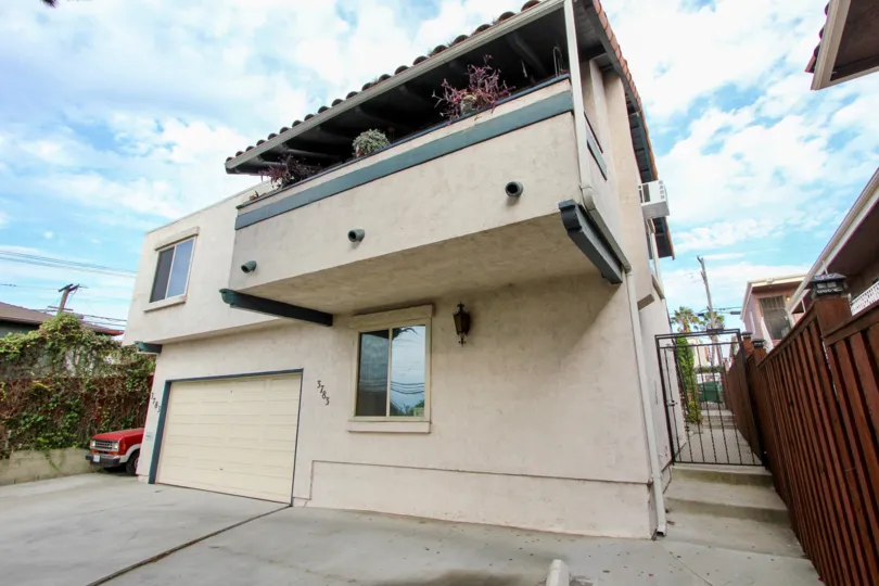 Overlooking balcony with tiled roof and wooden railing in Swift Homes.